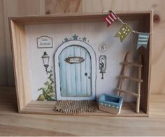 a doll house with a blue door and steps