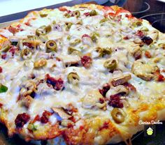 a close up of a pizza on a pan with the words monster pizza above it