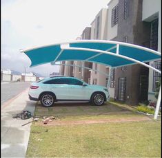 a car parked under an awning in front of a building