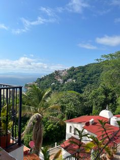 a view of the ocean and trees from a balcony