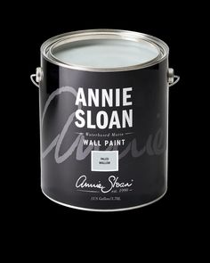 an open can of annie sloan's wall paint on a black background with the words annie sloan painted in white