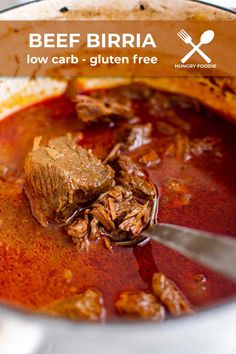 a pot full of beef and tomato soup with a spoon in the bowl next to it