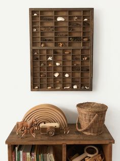 a wooden shelf filled with books and toys