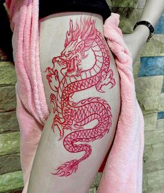 a woman with a dragon tattoo on her stomach