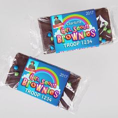 two chocolate brownies wrapped in cellophane on top of each other with the words girl scouts troop 1234