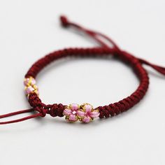 Material: Polyester Jade Thread Fashion Element: Peach Blossom Style: Mori style Adjustable Burgundy Bracelets, Adjustable Rose Red Flower Jewelry, Bohemian Red Jewelry With Flower Decoration, Bohemian Red Flower Bracelets, Mori Style, Braided Rope Bracelet, Rope Bracelets, Knot Braid, Mori Fashion