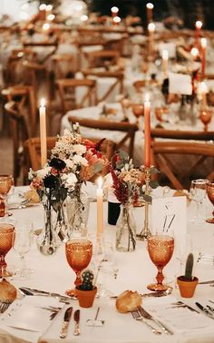 the table is set with candles and flowers