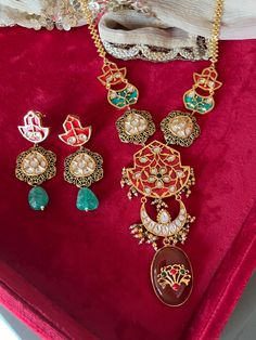 Elevate your style with our premium pendant necklace set. Crafted to perfection, this set exudes timeless beauty and unmatched quality, ensuring you stand out on every occasion. Product Details: Material: Crafted from high-quality brass, copper, dual tone plating, stones, beads, enamelled work, Kundan embellishments, this necklace boasts enduring quality and a radiant finish. Necklace Dimensions: Weight: 80 grams Drop Length: 12 inches. Closure Type: Hook Adjustable Size: Yes Earring Details: Weight (Per Pair): 32 grams. Length: 7 cm Width: 3 cm Closure Type: Push Back Closure with Extra support clip at the back. Unparalleled Craftsmanship: Our artisans have poured their skill and passion into creating a set that will leave admirers in awe. Compliment Magnet: Be prepared for a shower of co Fusion Style Jewelry Sets With Pendant For Celebration, Fusion Style Pendant Jewelry Sets For Celebration, Elegant Meenakari Round Pendant Jewelry, Fusion Style Dual-tone Jewelry Sets As Gift, Fusion Dual-tone Jewelry Set For Gift, Fusion Dual-tone Jewelry Set Gift, Festive Fusion Style Jewelry Sets For Gift, Fusion Style Hand Set Necklace As Gift, Fusion Meenakari Jewelry Sets For Gift