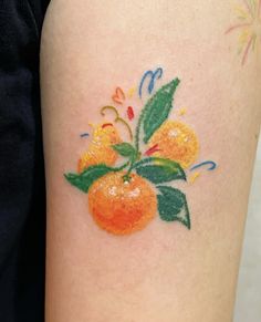 an orange with leaves and flowers painted on it's side calf sleeve tattoo design