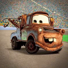 the tow truck from disney pixar is driving down the road in front of a stadium