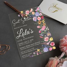 an elegant floral birthday party is set up on a table next to flowers and scissors