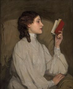 an image of a woman holding a book in her hand and looking at the viewer