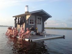 some people are sitting in the water by a house