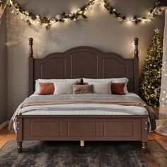 a large bed in a room with christmas lights on the wall and carpeted floor