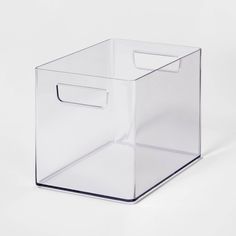 a clear plastic box with a handle on the top and bottom, sitting on a white surface