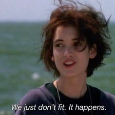 a woman with short hair standing in front of the ocean and saying we just don't fit it happens