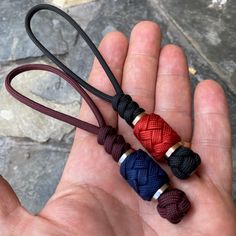 two different colored ropes in the palm of someone's hand, one red and one blue