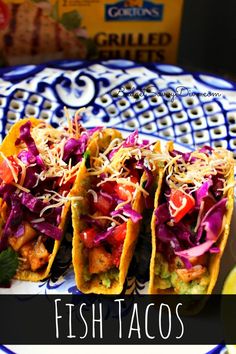 fish tacos on a plate with limes and cilantro in the background