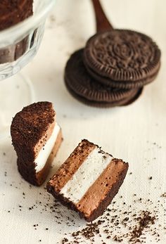 two pictures of oreo cookies with white and chocolate frosting, one has an oreo cookie on it