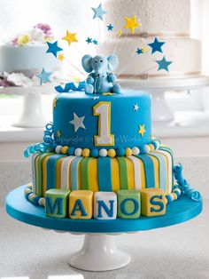 a blue and yellow cake with the number one on it