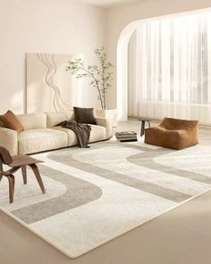 a modern living room with white walls and carpeted flooring, beige furniture and large windows