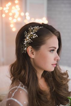 a woman wearing a hair comb with pearls on it