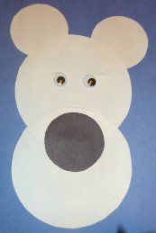 a paper cut out of a bear with eyes and ears on it's face