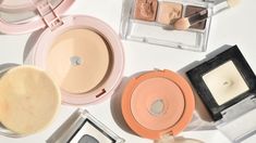 there are many different types of cosmetics on the table with it's lids open