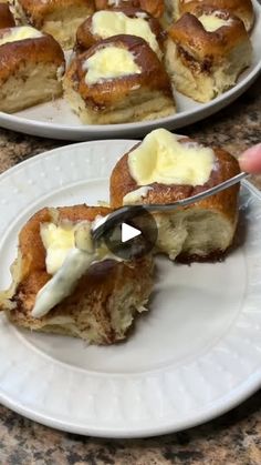 two white plates topped with pastries on top of a table