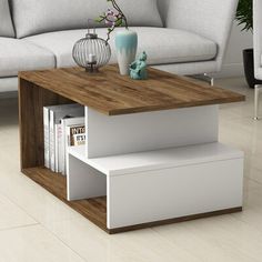 a living room with a couch, coffee table and bookshelf on the floor