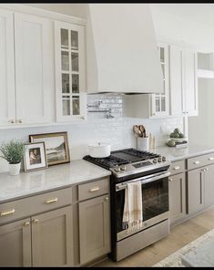 a kitchen with an oven, stove and pictures on the counter top in front of it