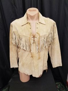 Vintage 1970's Genuine Leather by Scully Tan Suede Fringe Cowboy Rancher West Wear Pullover Lace Up Shirt, 48 Chest.  Shirt has a lace up neckline and lace up lower sides, and decorative fringe all the way around the chest, and also down the sides of the sleeves. Shirt is in excellent vintage condition.  See pics! Measurements: shoulder to shoulder 20 1/2 in, chest 48 in, waist 44 in, sleeves from shoulder to cuff 23 in, sleeves from pit to cuff 18 1/2 in, neck to bottom length 27 1/2 inches. Lace Up Shirt, Laced Up Shirt, Western Chic, Suede Fringe, Tan Suede, 1970s, Mens Jackets, Cowboy, Genuine Leather