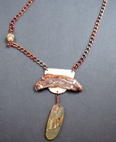 One of a kind OOAK  handmade jewelry created by Mary Heuer in her Wisconsin studio. Petrified wood is tab set in copper with a 1/1/2 inch long amber dangle hanging below and is finished off with copper chain.  This casual piece slips over your neck and measures approximately 28 inches long including the dangle.  Fun.  This necklace was originally priced at $125, now reduced to $95. All of my one of a kind necklaces and bracelets are shipped USPS Priority Mail within 1-5 days after receipt of pay Rust Colored Pendant Necklace As Gift, Rust Colored Pendant Necklace For Gift, Handmade Rust Jewelry As Gift, Hand Forged Amber Necklace As Gift, Handmade Rust-colored Jewelry Gift, Handmade Rust Jewelry For Gift, Hand Forged Amber Necklace For Gift, Unique Amber Necklaces With Natural Stones, Rust Pendant Necklace For Gift