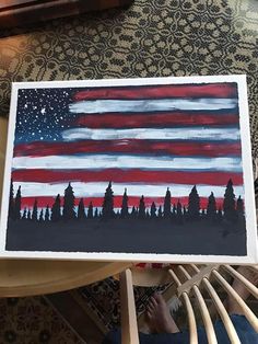 an american flag is painted on a piece of paper in the middle of a chair