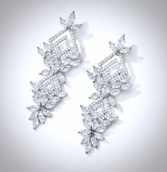 A delightfully unique pair of wedding earrings with a geometric appeal. The flawlessly faceted cubic zirconia stones capture the light in a dazzling array of sparkles, while the delicate links add fluidity and motion. The earrings are rhodium plated for a bright finish which enhances the intricate detailing and conveys a modern take on old elegance. Length: 2.5" (approx. 6.5cm); Width: 0.9" (approx. 2.4cm); Weight: 16g. Hypoallergenic - lead, nickel and cadmium free. This exquisite design will a Dazzling Diamond White Chandelier Earrings With Elegant Design, Dazzling Cubic Zirconia Linear Earrings For Wedding, Diamond Cut Cubic Zirconia Linear Drop Earrings, Luxury Diamond Crystal Earrings For Wedding, Cubic Zirconia Diamond Cut Drop Earrings, White Cubic Zirconia Diamond Earrings With Elegant Design, Cubic Zirconia Diamond White Earrings, Elegant Bridal Earrings With Diamond Cut Crystal, Diamond Cut Cubic Zirconia Chandelier Dangle Earrings