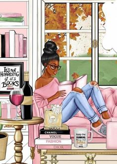 a woman sitting on a pink couch reading a book