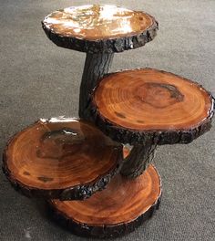 three wooden slices stacked on top of each other in the middle of a carpeted area