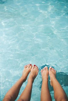 two people with their feet in the water