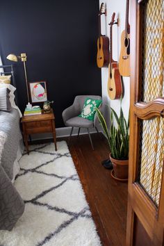 a bedroom with guitars hanging on the wall