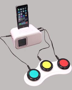 a white controller with three buttons and a cell phone in the center, connected to it