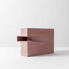 a pink sculpture sitting on top of a white table