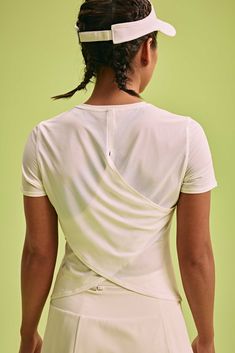 Want to upgrade your classic tee? Look no further than the Cross-back T-shirt, which features an elegant front and a sporty, convertible back. Made from a lightweight mesh fabric, this tee will keep you cool all season long. Details Materials & Care Shipping & Returns • Made from moisture-wicking, quick-drying fabric.• Cross-back panels provide ventilation and can be tied together for a knotted look.• Versatile length can be worn tucked or untucked. Size M is 18.8" in front length. • Materials: White Stretch Top With Mesh Back, White Gym Top With Mesh Back, Fitted Short Sleeve Workout T-shirt, Versatile Tops For Light Sports, White Functional Top With Mesh Back, Functional White Top With Mesh Back, Functional Short Sleeve Summer Tops, White Mesh Back Tops, White Athleisure Top With Mesh Back