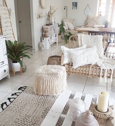 a living room with wicker furniture and rugs on the floor in front of it