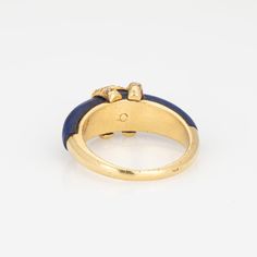 Vintage "Double C" Cartier diamond ring crafted in 18k yellow gold.    Diamonds total an estimated 0.15 carats (estimated at G-H color and VS2-SI1 clarity). Lapis lazuli tapers and measures from 6mm to 4.5mm. Note: some wear to the lapis (surface abrasions) and a small fissure underneath the CC logo (visible under a 10x loupe).    The elusive 'Double C' ring is a classic made by Cartier in the 1970s. Diamonds adorn the 'CC' motif, perched upon rich cobalt blue lapis lazuli. The ring is great worn alone or stacked with your fine jewelry from any era and would also make a unique choice as an alternative wedding ring. The intertwining 'Cs' make a nice representation of a couple joining together as one. The ring does not come with Cartier papers or a box.   The ring is in good condition and wa Classic Cartier Rings With Prong Setting, Cartier Yellow Gold Diamond Ring For Anniversary, Gold Cartier Diamond Ring, Cartier Gold Ring With Single Cut Diamonds, Cartier Yellow Gold Diamond Rings, Cartier Fine Jewelry Rings With Prong Setting, Cartier Rings With Prong Setting Fine Jewelry, Cartier Rings With Prong Setting, Gold Cartier Diamond Ring For Anniversary