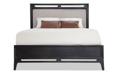 the bed has two pillows on it and is made up with black wood trims