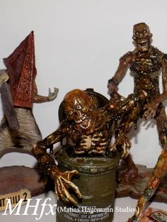 three zombie figurines are posed next to each other