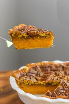 a piece of pecan pie being lifted from a dish with a spoon over it