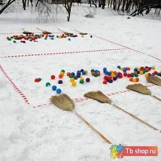 several brooms and colorful balls are arranged in the shape of a square on snow