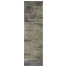 a gray rug with an abstract design on the bottom, and a white background behind it