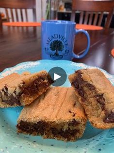 chocolate chip cookie bars on a blue plate with a coffee mug in the back ground